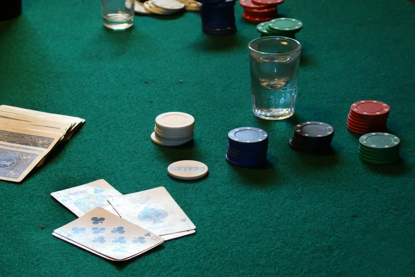 Poker chips and cards on a table, illustrating whether online poker is legal in NY