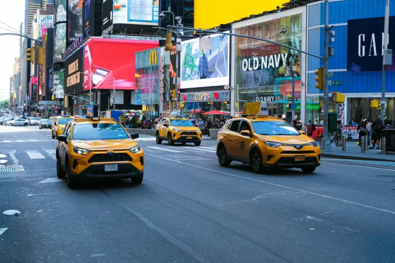 Cars and yellow taxis on a New York City street, illustrating legal tint in NY